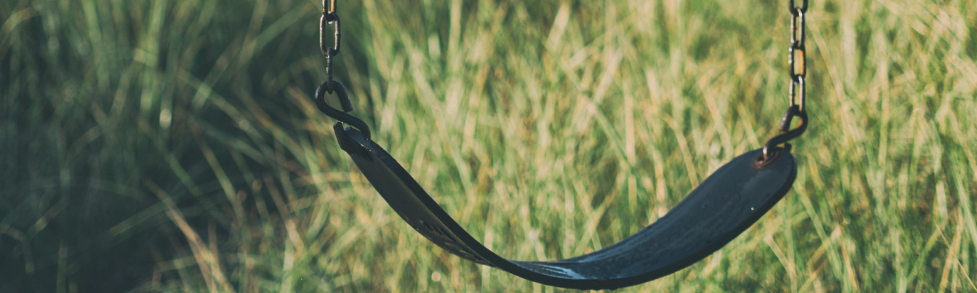 Empty swing in a field